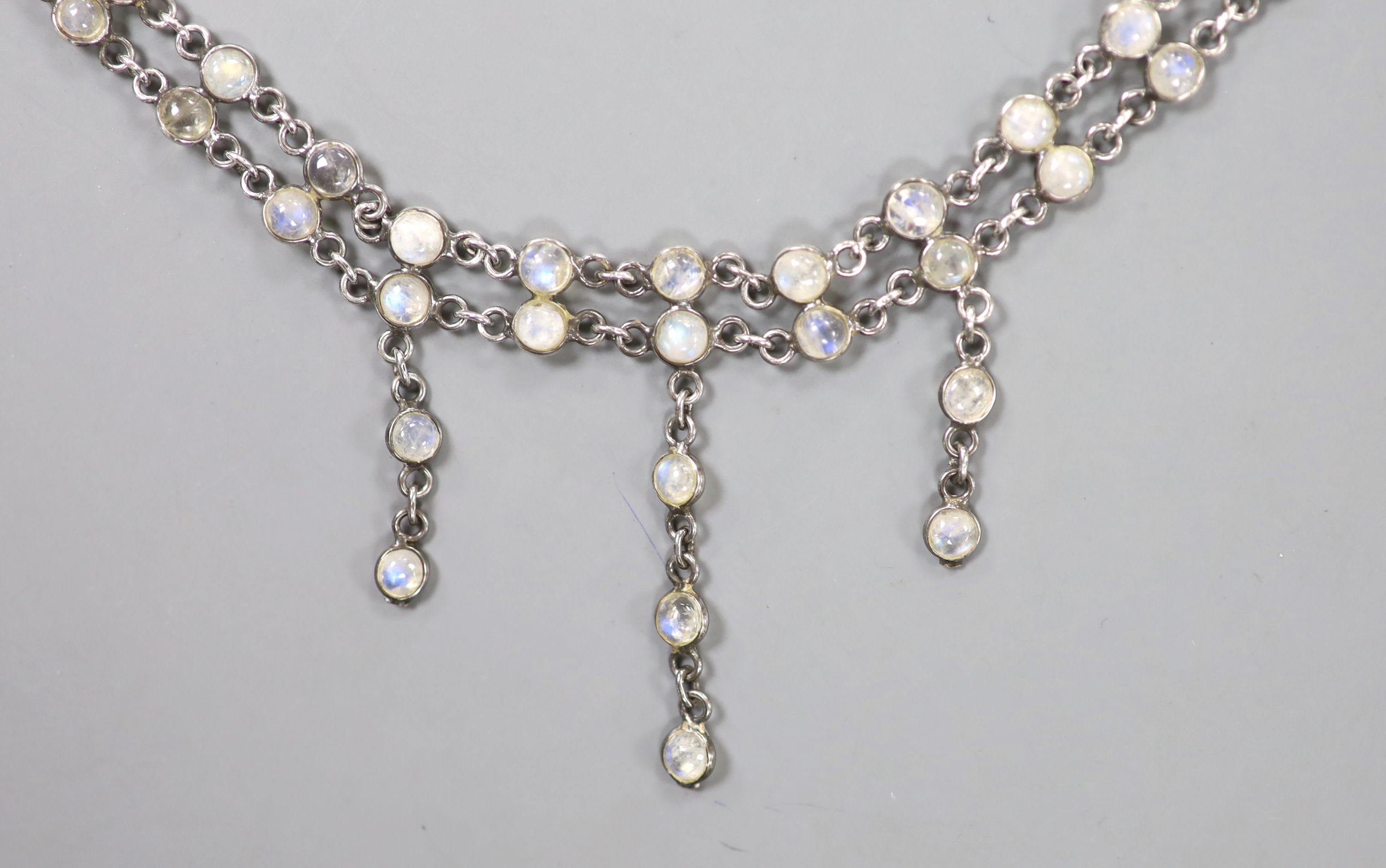 A white metal and cabochon moonstone set fringe drop necklace, approx. 42cm, excluding the drops.